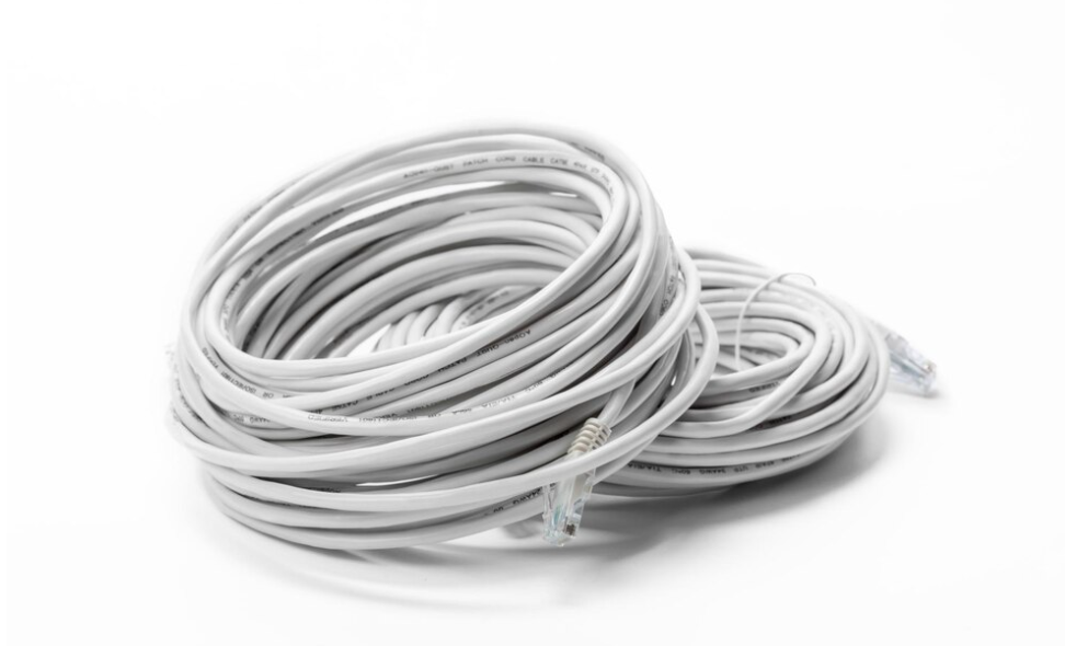 Coiled white ethernet cables with connector plugs at their ends