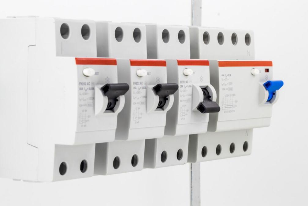 white electrical circuit breaker with multiple red switches and one blue switch