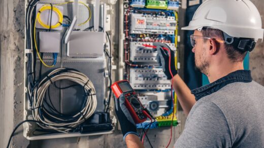 Close up of electrical technician working in a switchboard with fuses
